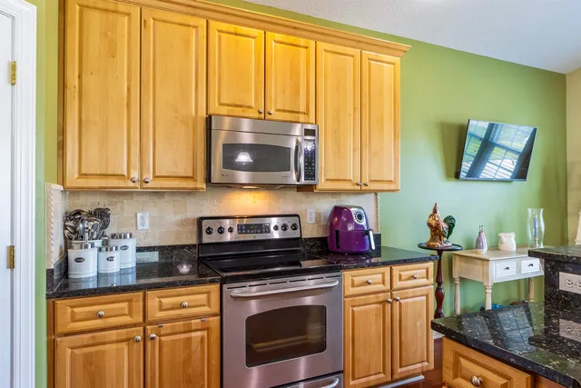 a living room with furniture and a book shelf
