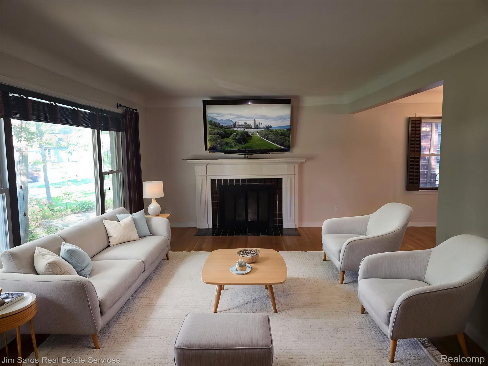 1762 Bournemouth Road Grosse Pointe, MI 48236 - Photo 4 of 21 Living room featuring a fireplace with a white mantel and black tile surround