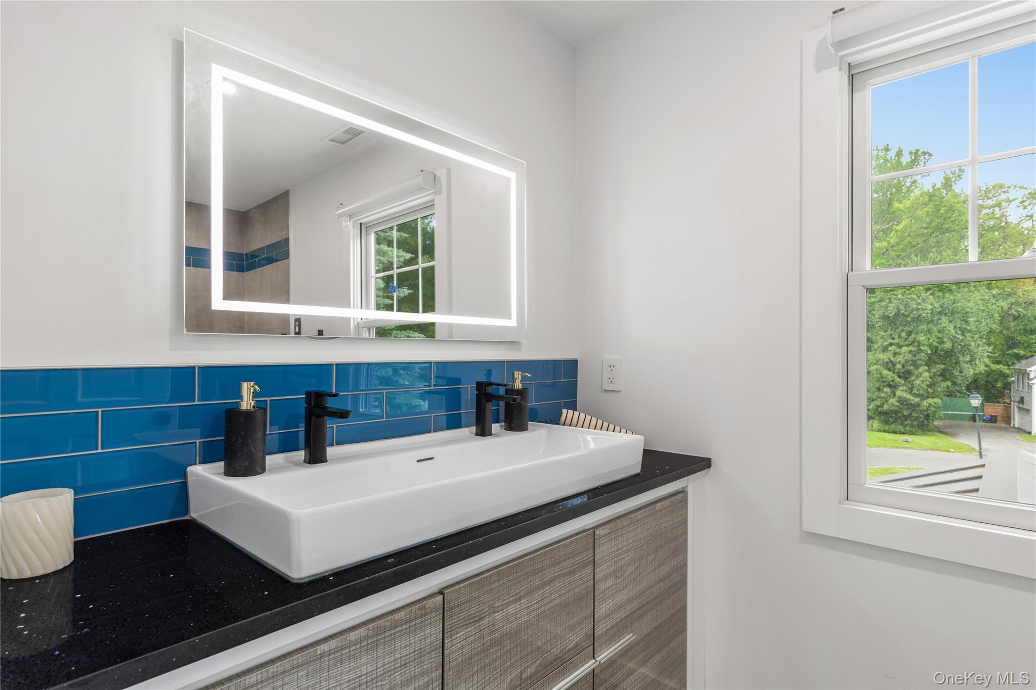 19 John Jay Place Rye, NY 10580 - Photo 32 of 45 The bright, renovated hall bathroom serves two bedrooms, has a double vanity and storage drawers.