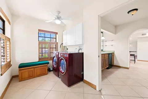a view of a storage & utility room with two washing machine