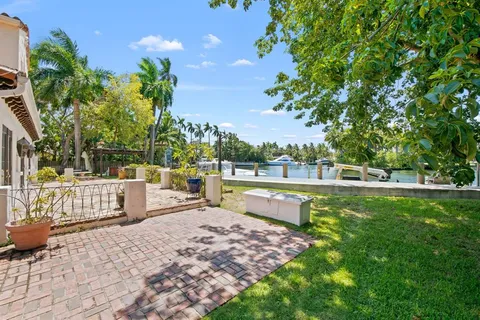 a view of a lake with a bench and trees around