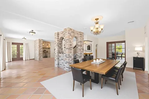 a view of a dining room with furniture and chandelier