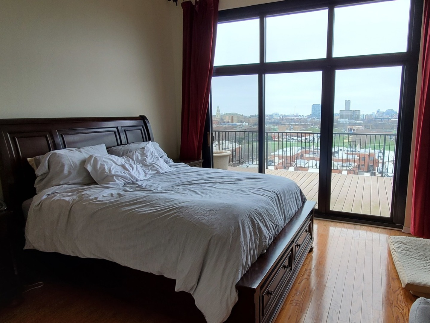 1525 South Sangamon Street, Unit 802P Chicago, IL 60608 - Photo 15 of 32 a bedroom with a large bed and a large window