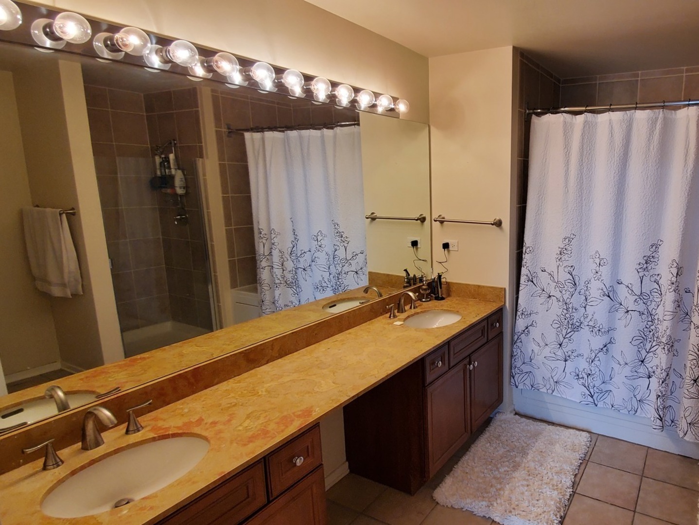 1525 South Sangamon Street, Unit 802P Chicago, IL 60608 - Photo 24 of 32 a bathroom with a sink double vanity and a mirror