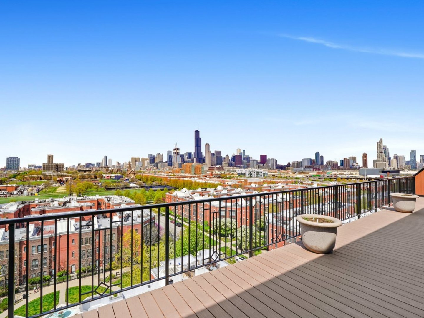 1525 South Sangamon Street, Unit 802P Chicago, IL 60608 - Photo 5 of 32 a view of roof deck with two chairs and wooden floor