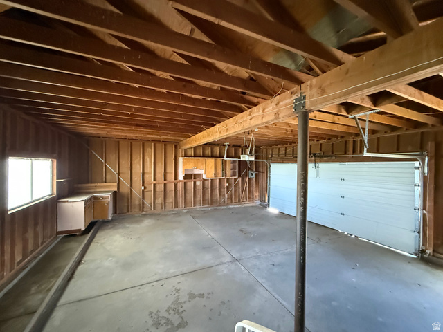 2002 Lund Road Bancroft, ID 83217 - Photo 9 of 28 Exposed wood ceiling beams and framing characterize this garage space