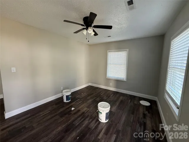 a view of a livingroom with a hardwood floor and a ceiling fan