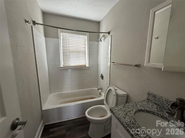 a kitchen with stainless steel appliances granite countertop a refrigerator a stove a sink and a microwave