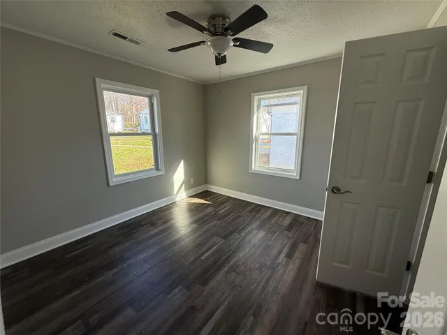 a kitchen with wooden floors and white appliances