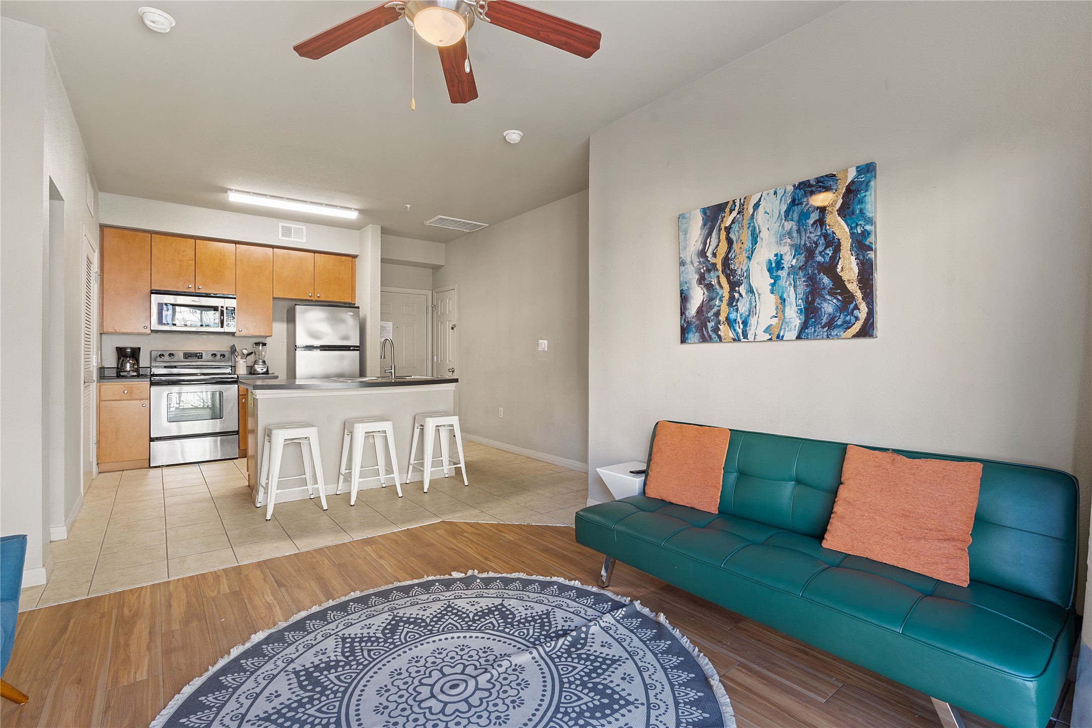 2515 Pearl Street, Unit 314 Austin, TX 78705 - Photo 16 of 17 Living area featuring light wood-style floors and a ceiling fan