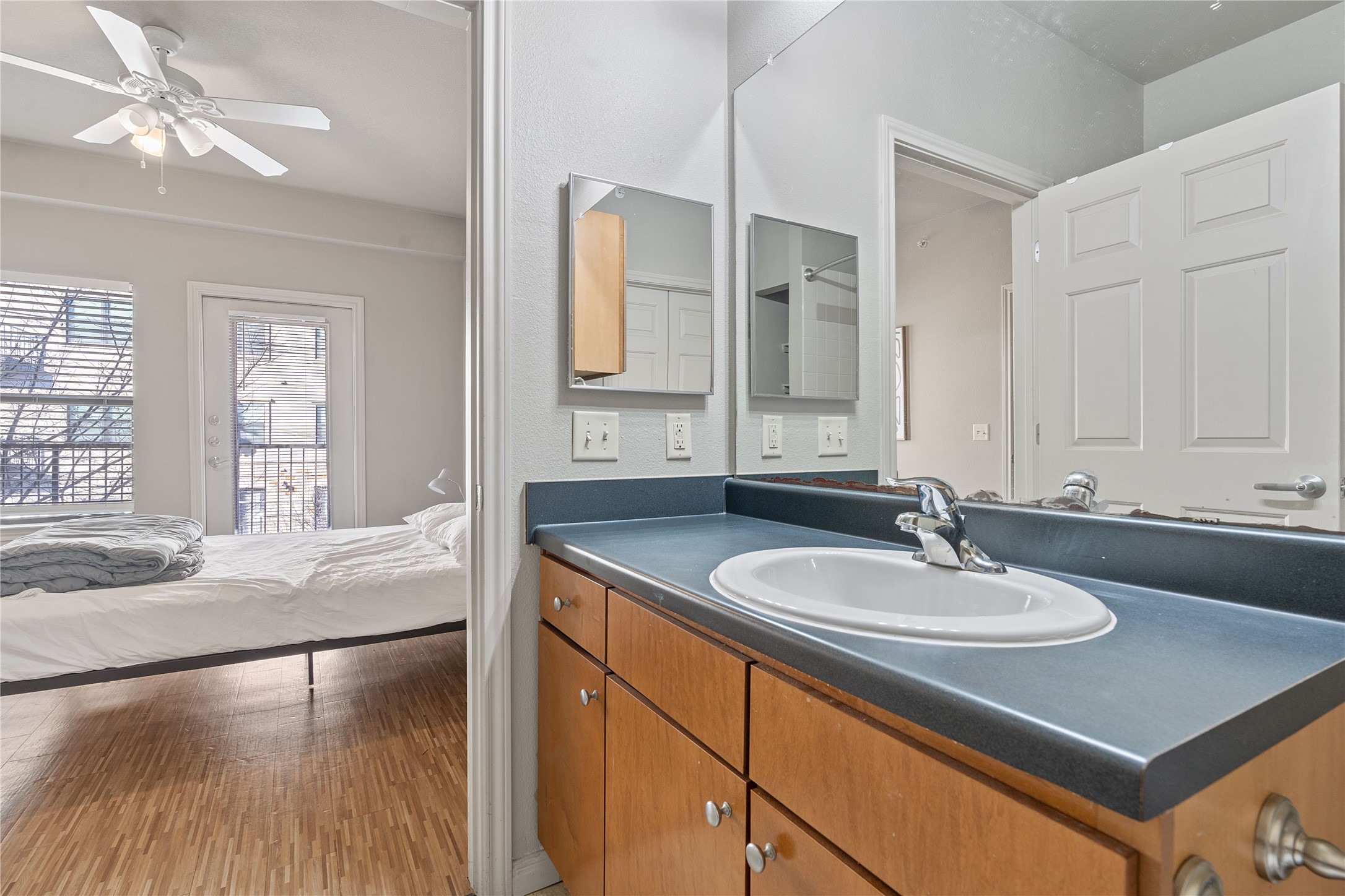 2515 Pearl Street, Unit 314 Austin, TX 78705 - Photo 5 of 17 Bathroom with vanity, ensuite bath, light wood-type flooring, and ceiling fan