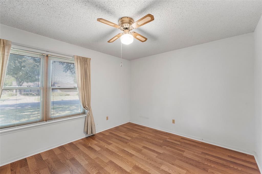 232 Monterrey Drive Hewitt, TX 76643 - Photo 14 of 27 wooden floor in an empty room with a window