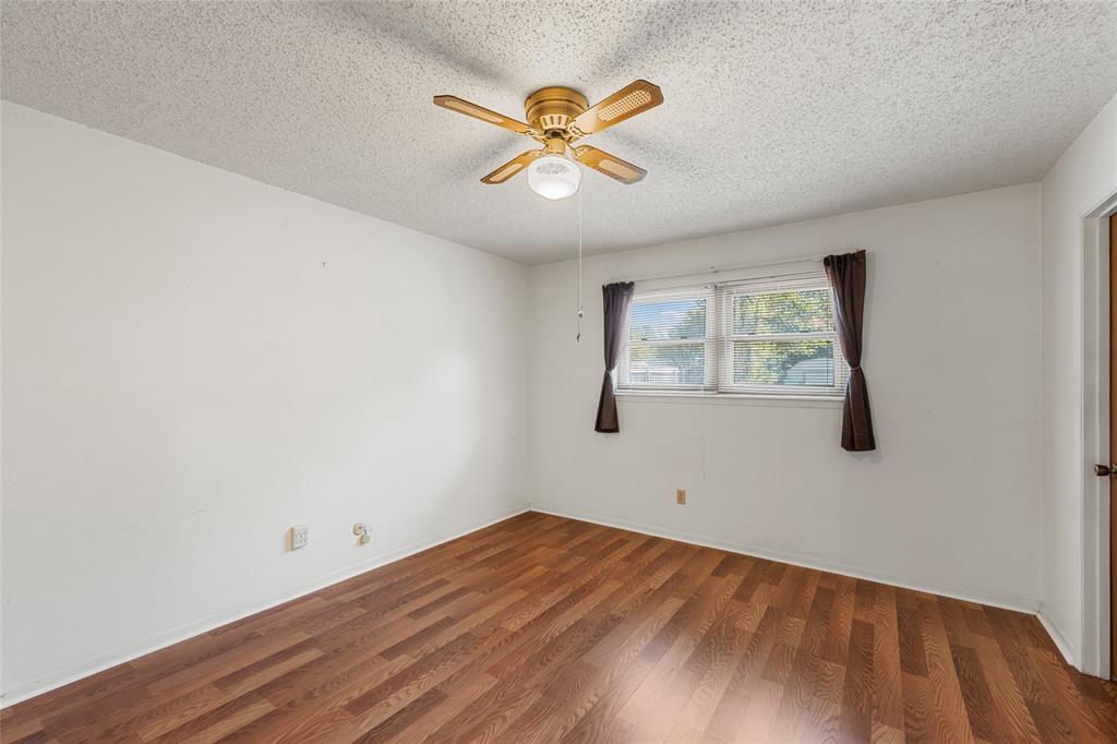 232 Monterrey Drive Hewitt, TX 76643 - Photo 17 of 27 wooden floor in an empty room with a window