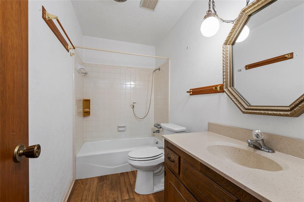 232 Monterrey Drive Hewitt, TX 76643 - Photo 18 of 27 a bathroom with a granite countertop sink toilet and shower