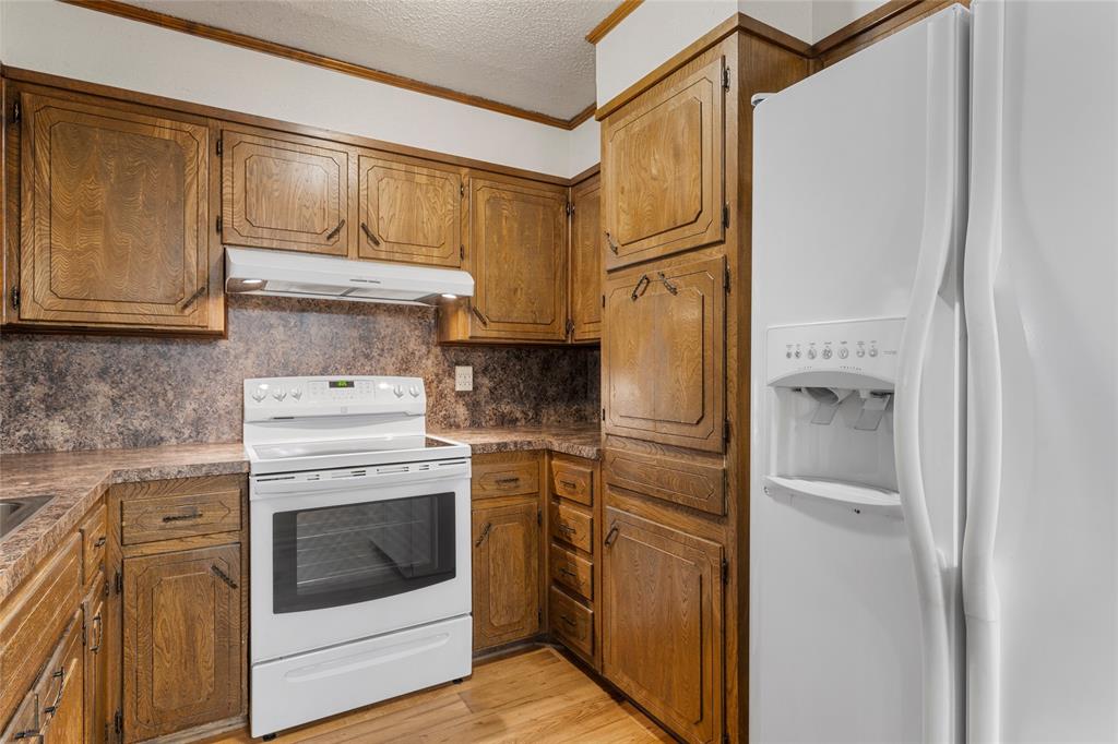 232 Monterrey Drive Hewitt, TX 76643 - Photo 9 of 27 a kitchen with a stove top oven sink and refrigerator
