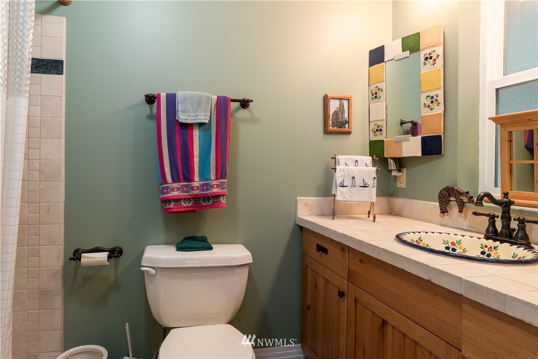 54 West Beach Path Olga, WA 98279 - Photo 14 of 39 a bathroom with a toilet a sink and mirror