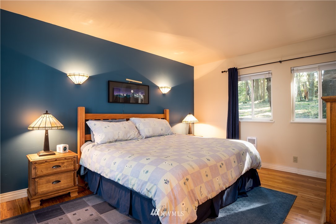 54 West Beach Path Olga, WA 98279 - Photo 18 of 39 a bedroom with a bed and a lamp