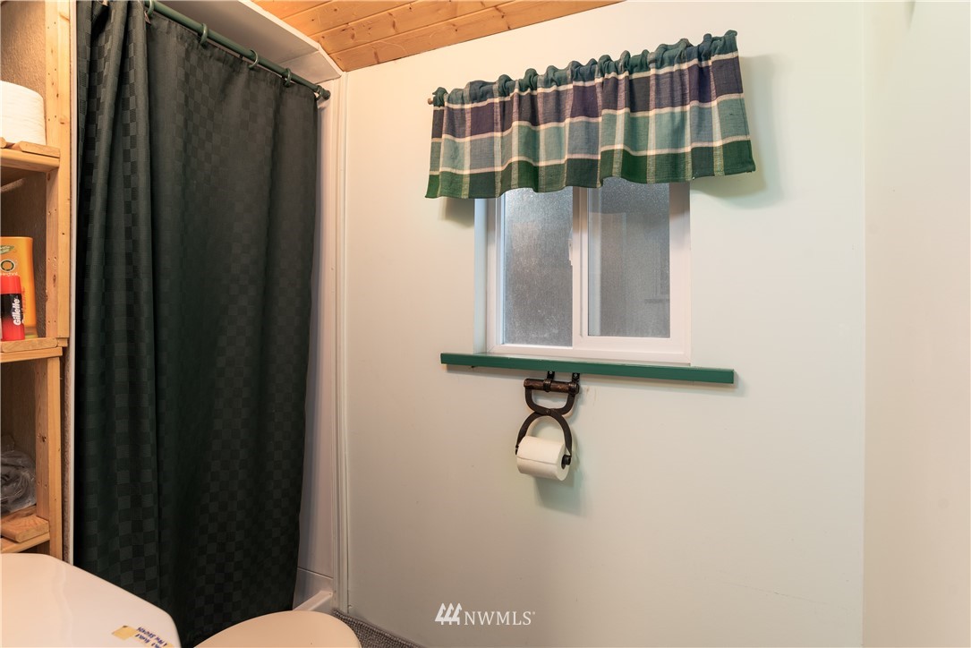 54 West Beach Path Olga, WA 98279 - Photo 25 of 39 a bathroom with a shower curtain and a sink
