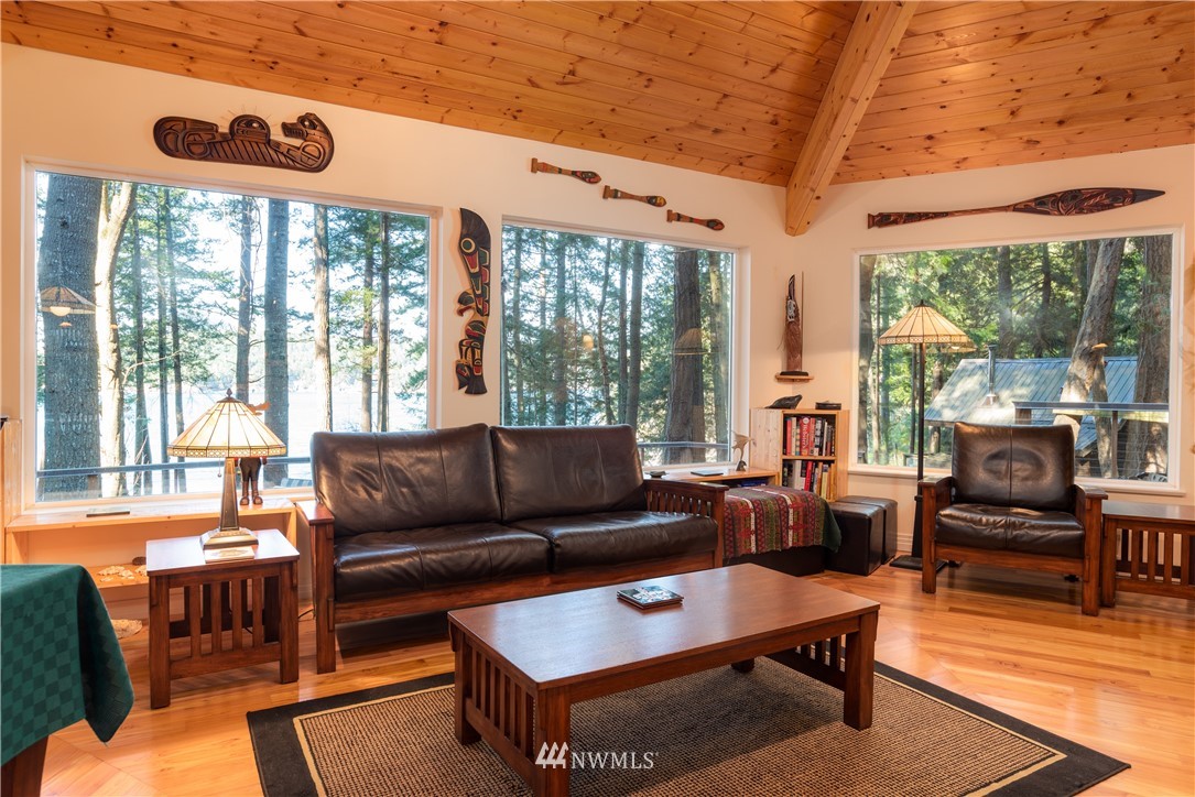 54 West Beach Path Olga, WA 98279 - Photo 7 of 39 a living room with furniture a table and a large window