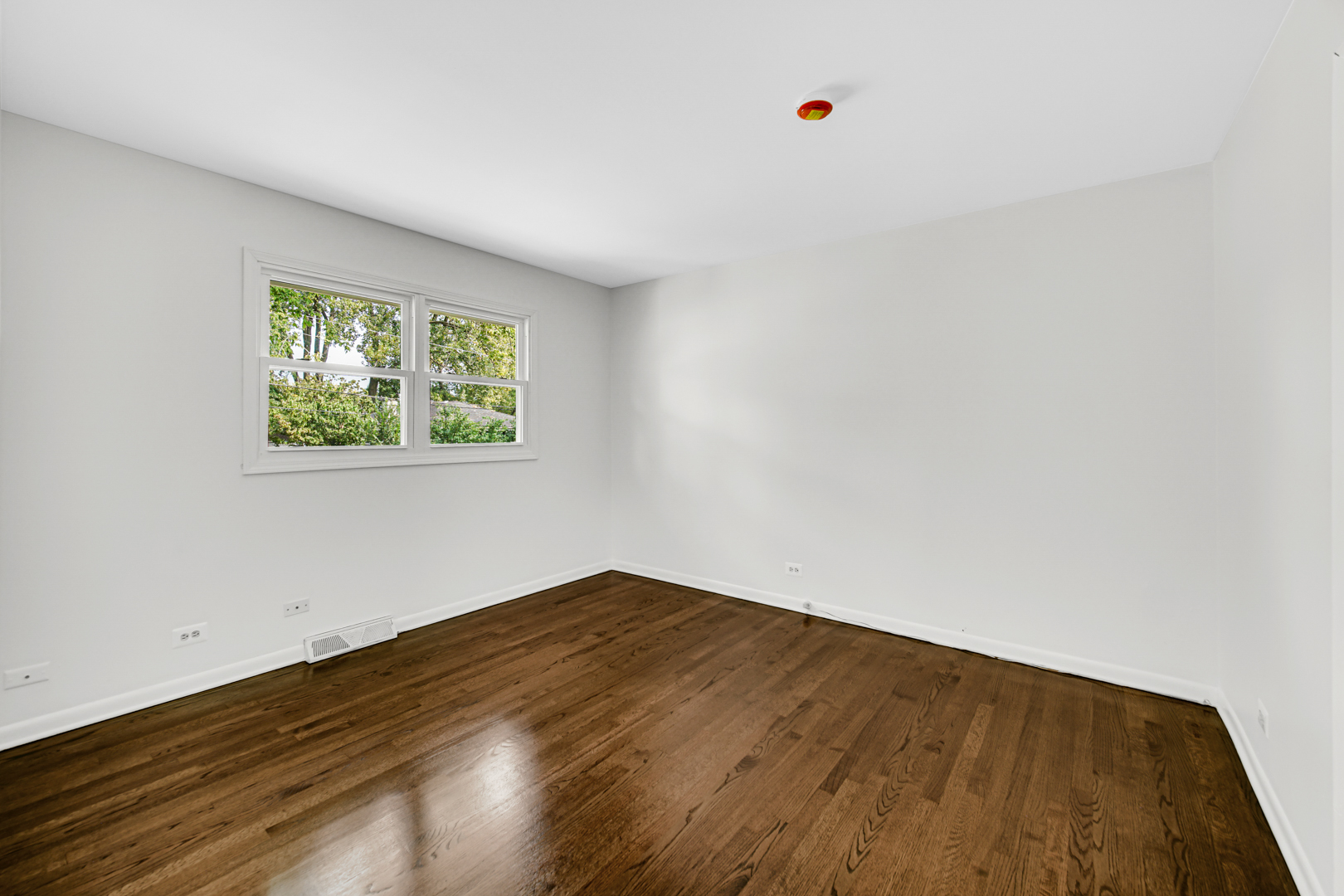 214 Oakleaf Road Lake In The Hills, IL 60156 - Photo 14 of 25 an empty room with wooden floor and windows