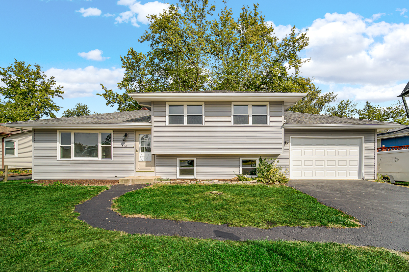 214 Oakleaf Road Lake In The Hills, IL 60156 - Photo 25 of 25 a front view of a house with a garden and yard