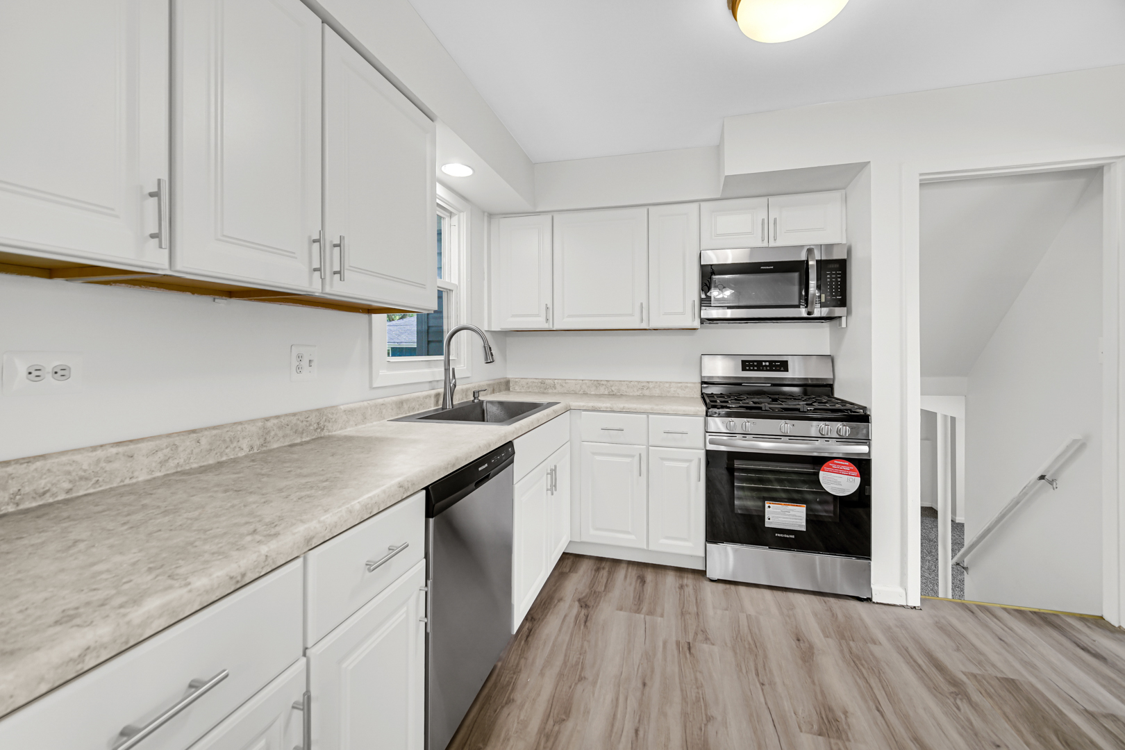 214 Oakleaf Road Lake In The Hills, IL 60156 - Photo 4 of 25 a kitchen with stainless steel appliances granite countertop a sink and a stove