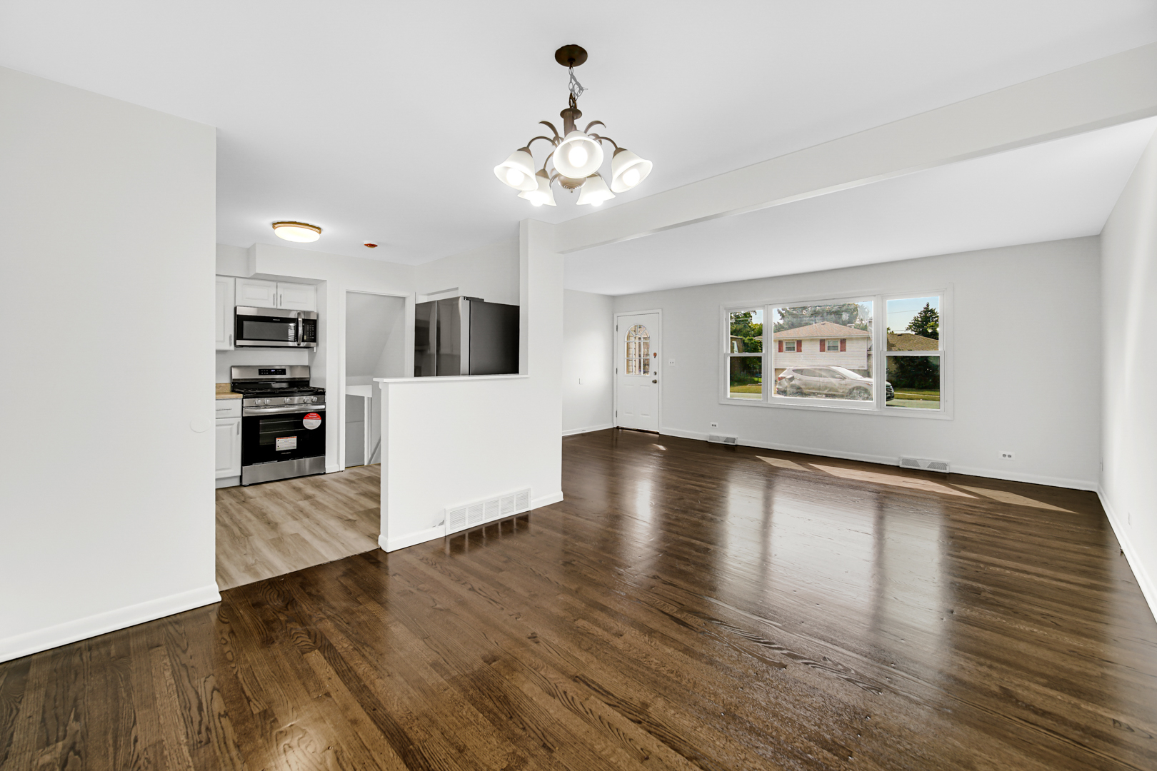 214 Oakleaf Road Lake In The Hills, IL 60156 - Photo 7 of 25 a view of a kitchen with wooden floor and a kitchen