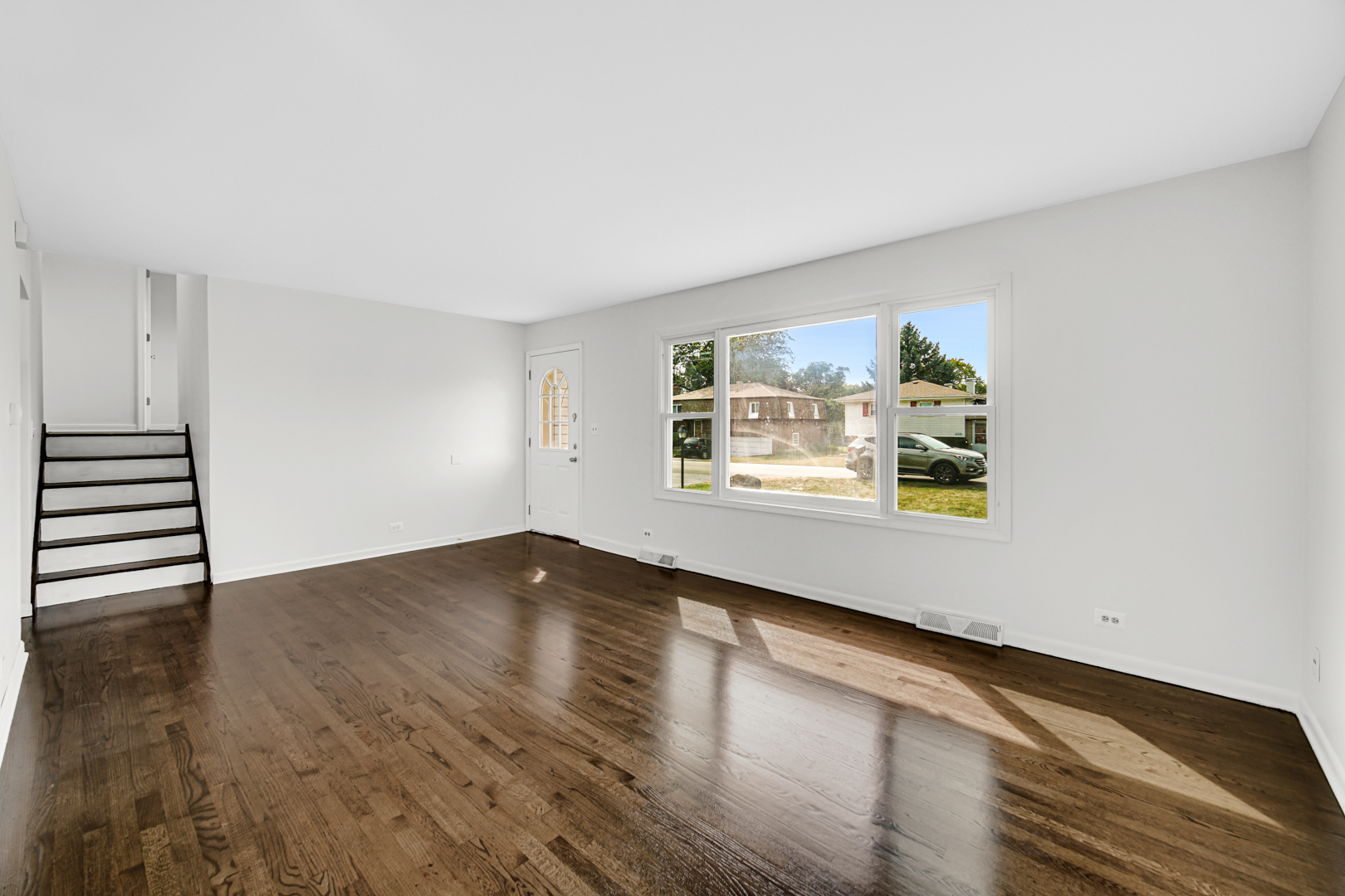 214 Oakleaf Road Lake In The Hills, IL 60156 - Photo 10 of 25 an empty room with wooden floor and windows