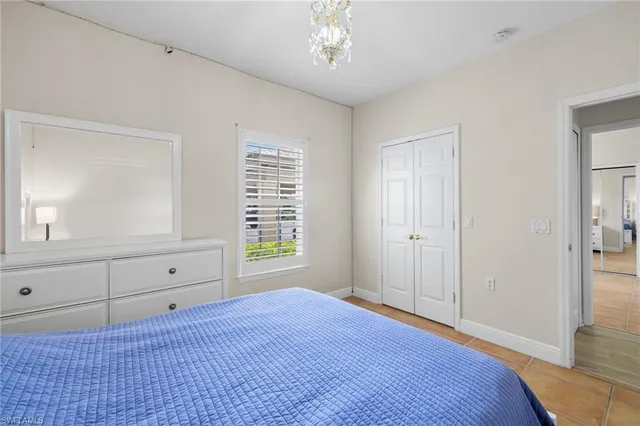 a view of a livingroom with an empty space & a window