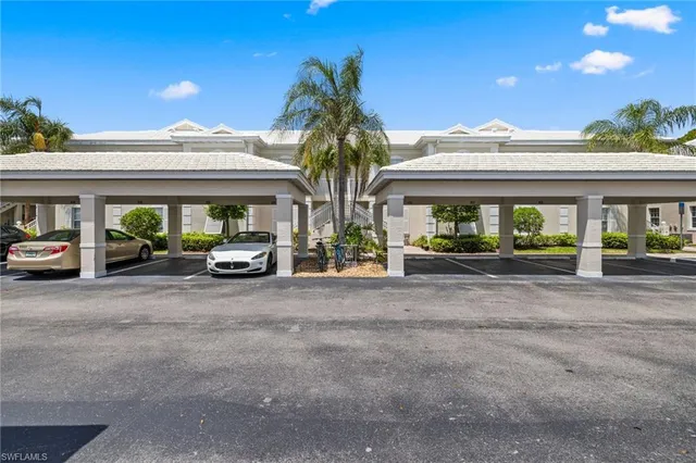 a couple of cars parked in front of a building