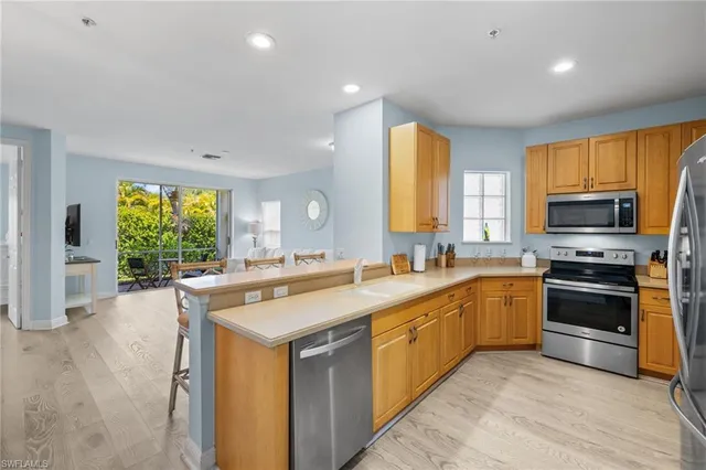 a kitchen with stainless steel appliances granite countertop a sink and cabinets