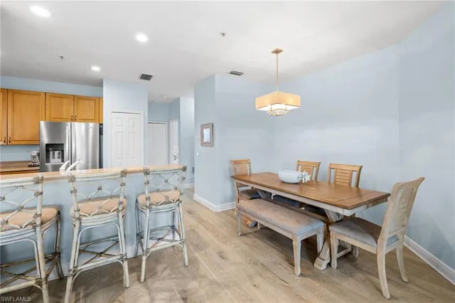 a dining room filled chandelier and kitchen view