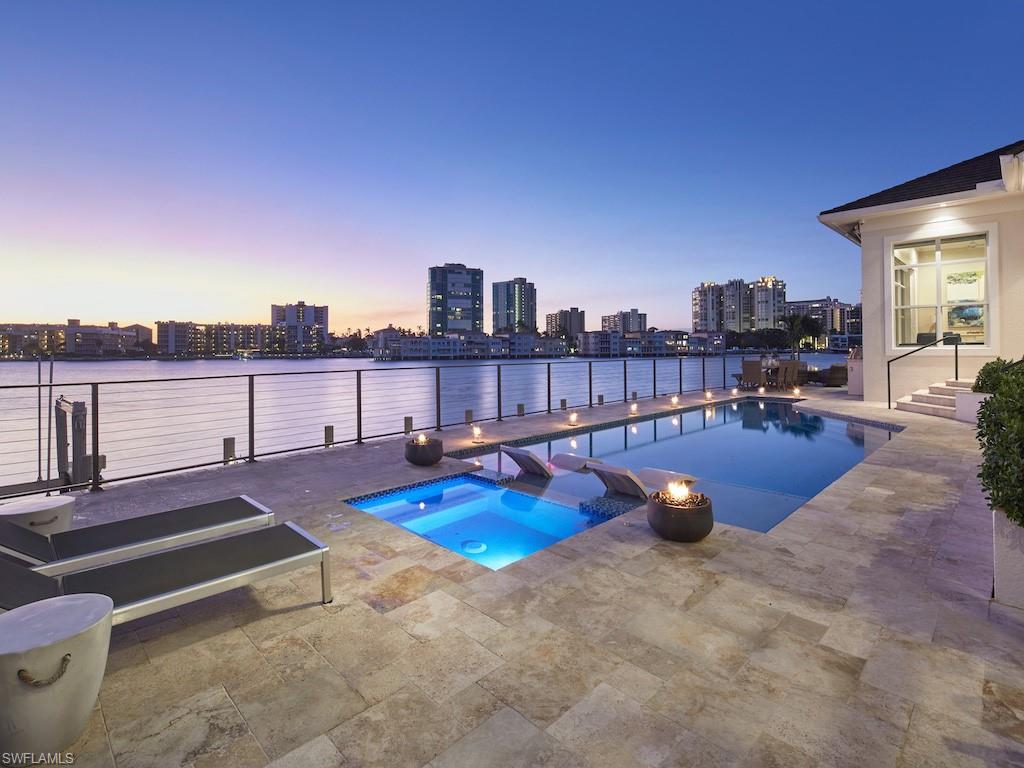 a view of a swimming pool with lounge chairs