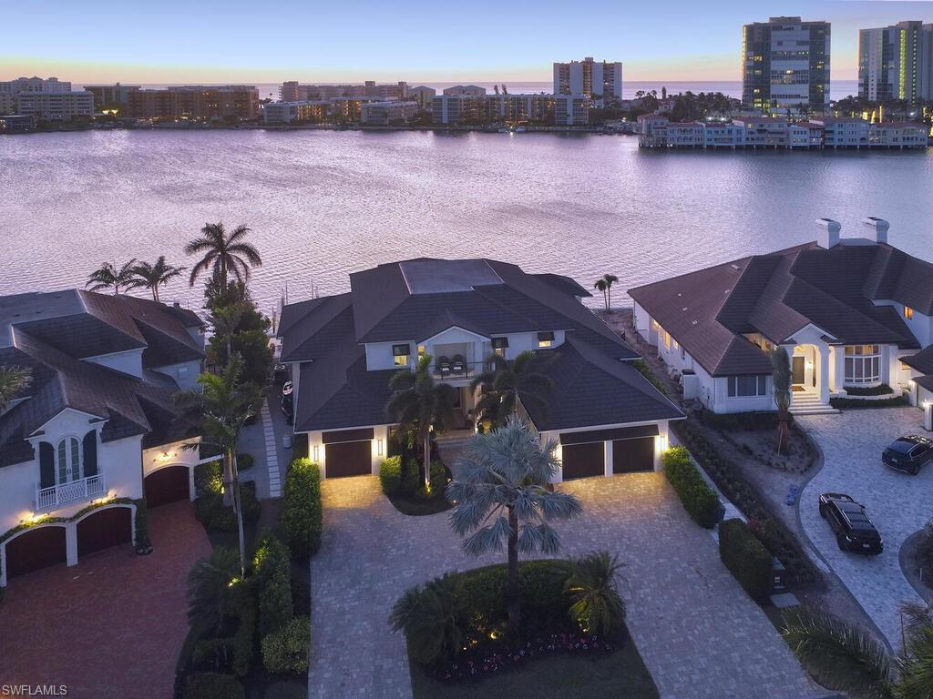246 Mermaids Bight Naples, FL 34103 - Photo 16 of 16 an aerial view of a house with a lake view