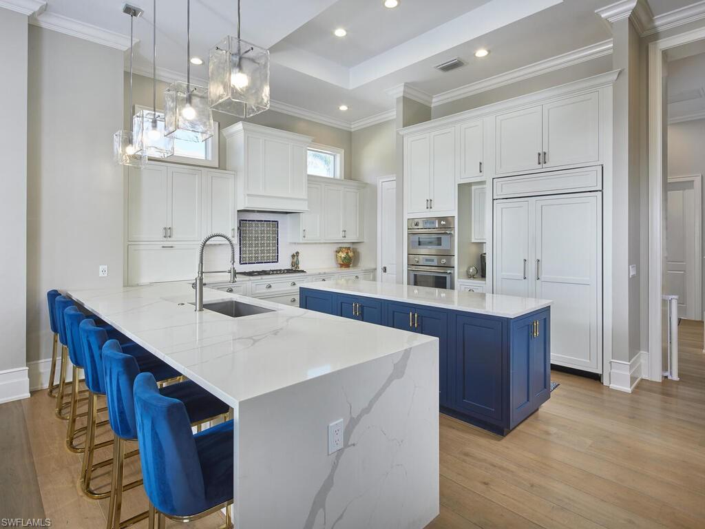 246 Mermaids Bight Naples, FL 34103 - Photo 6 of 16 a kitchen with kitchen island granite countertop a sink cabinets and window