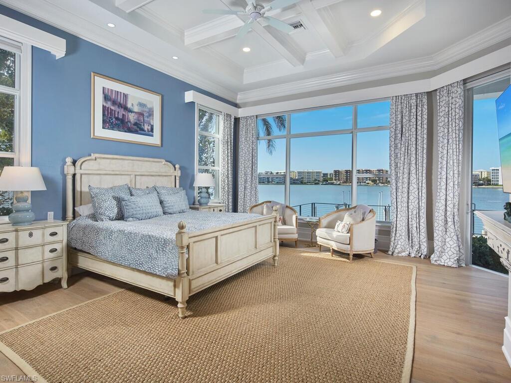 246 Mermaids Bight Naples, FL 34103 - Photo 7 of 16 a bed room with a bed and a large window