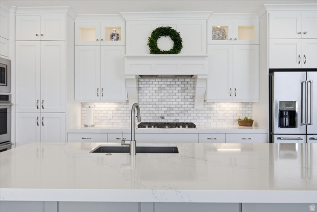 21 Pier Place Tooele, UT 84074 - Photo 16 of 112 Central kitchen island with a stone-finish countertop and integrated sink