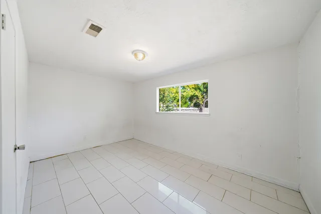 a spacious bathroom with a toilet a sink and a mirror