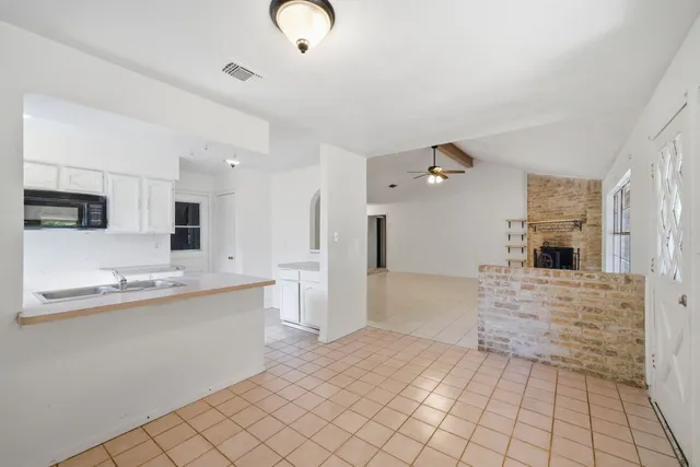 a kitchen with a sink cabinets and appliances