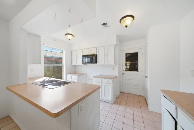 a kitchen that has a sink and a stove