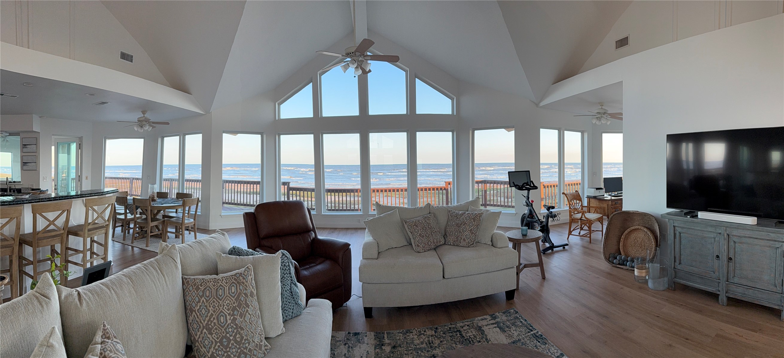 878 County Road 230 Sargent, TX 77414 - Photo 14 of 39 This spacious, open-concept living area features stunning ocean views through large, floor-to-ceiling windows.