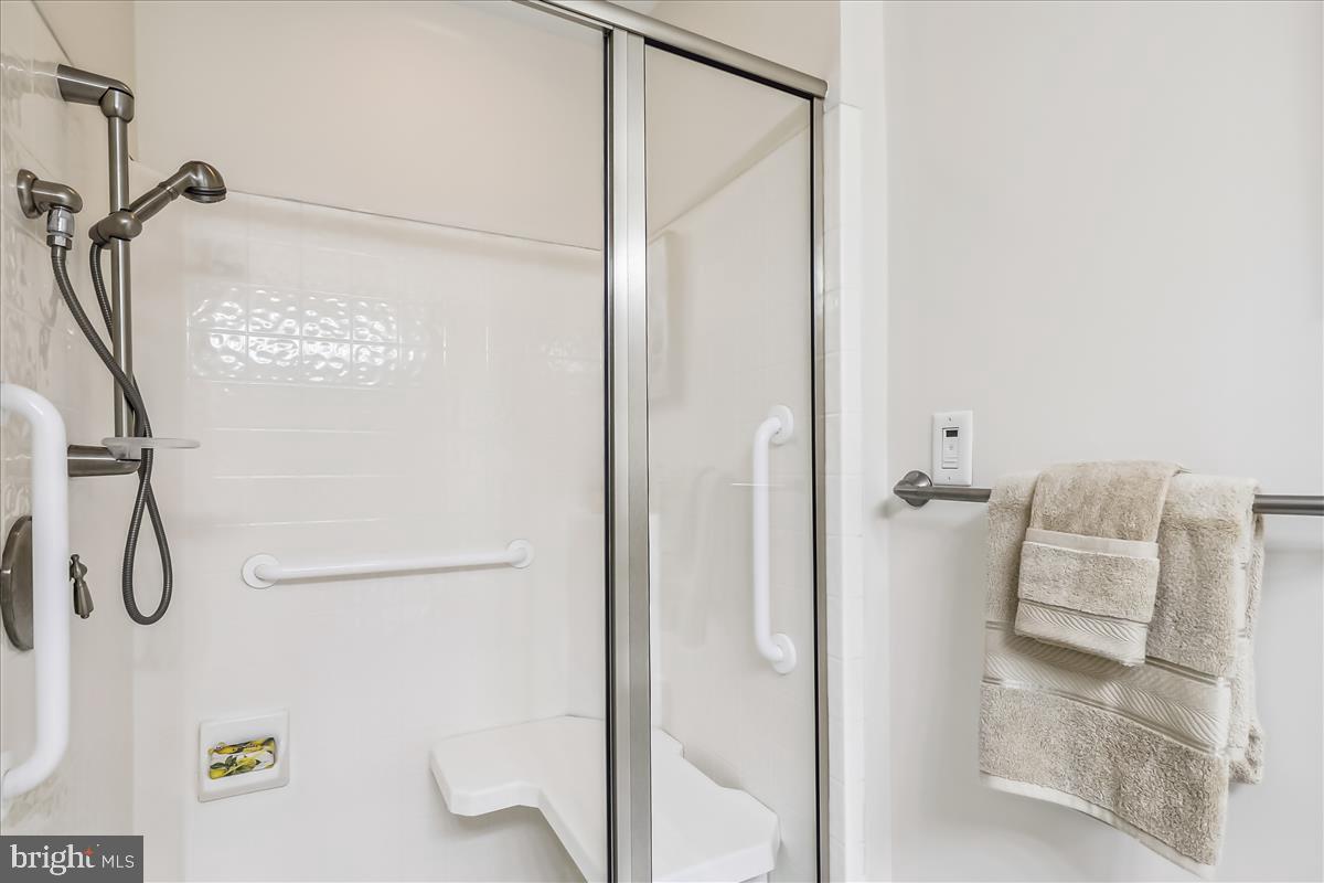 8300 Burdette Road, Unit 507 Bethesda, MD 20817 - Photo 30 of 64 Glass-enclosed shower with bench