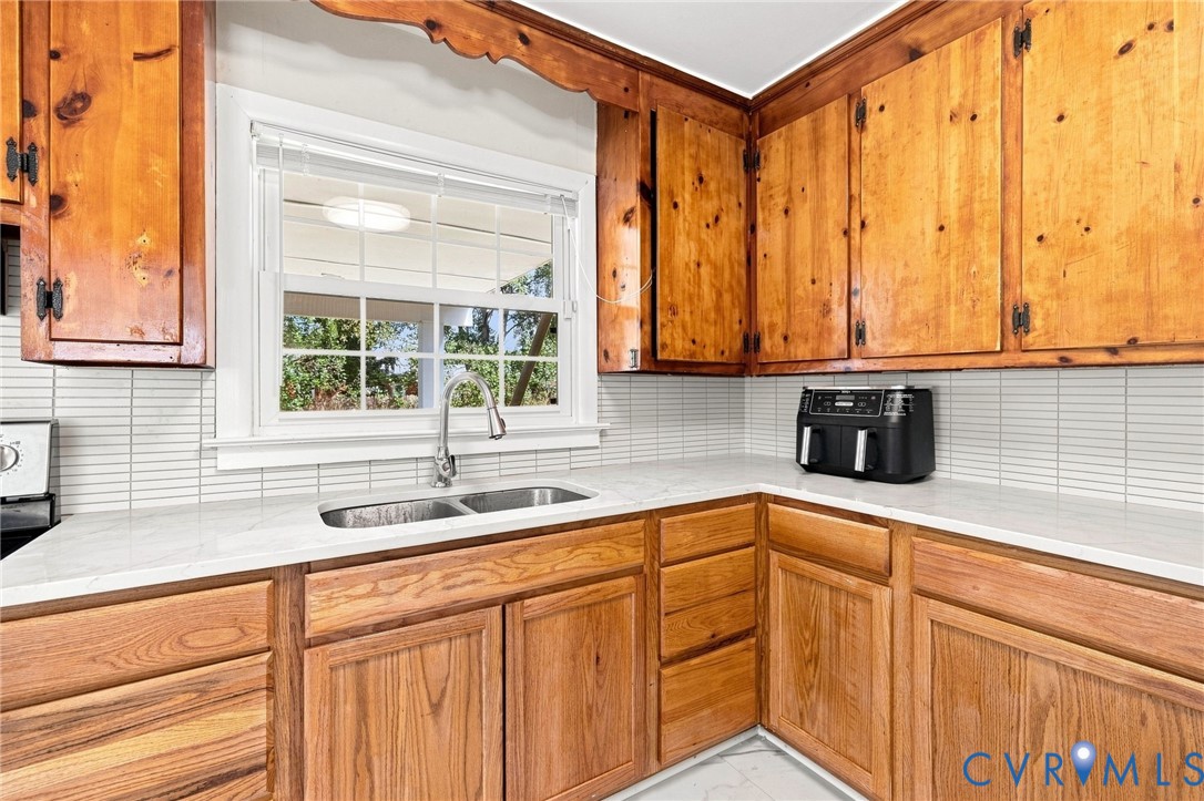 Wood cabinetry, white quartz countertops, stainles