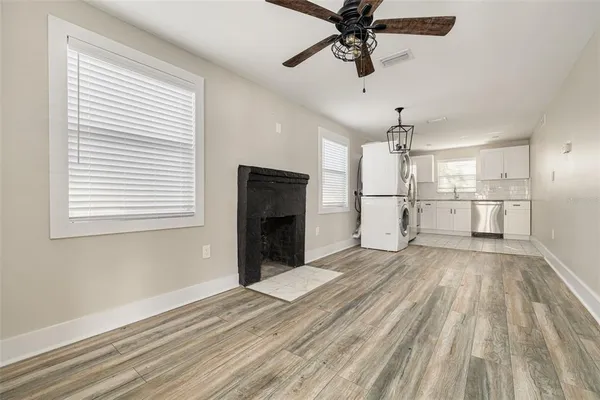 a view of empty room with wooden floor and windows