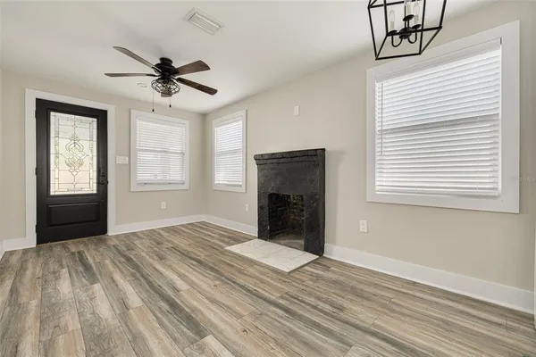 a view of empty room with window and ceiling fan