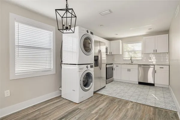 a utility room with sink dryer and washer