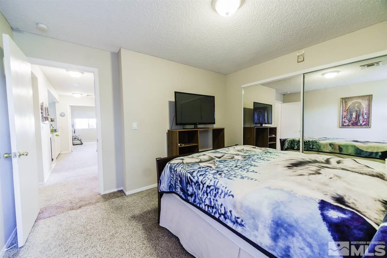 4275 Perro Lane Reno, NV 89502 - Photo 22 of 32 a bedroom with a bed and a flat screen tv