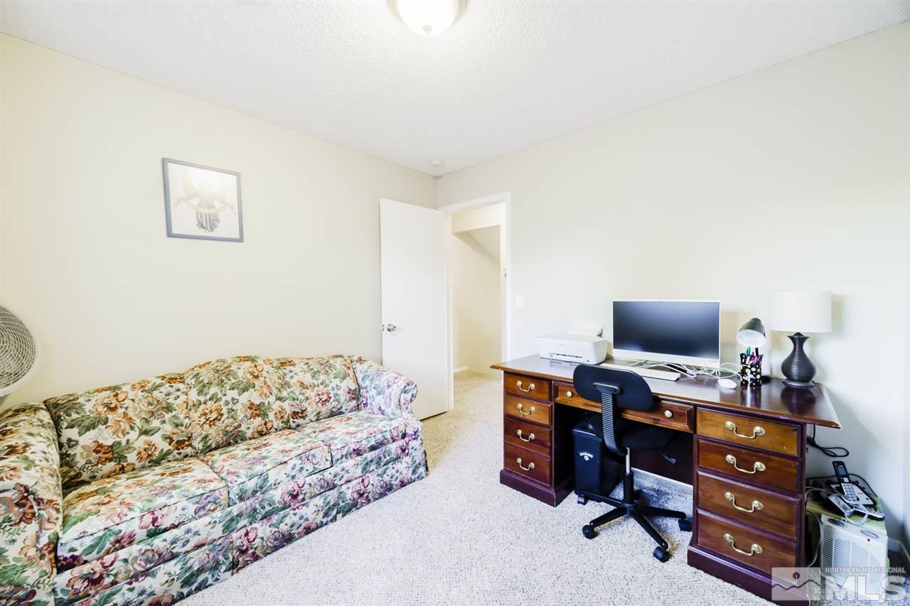 4275 Perro Lane Reno, NV 89502 - Photo 24 of 32 a bedroom with a bed and a computer on a desk
