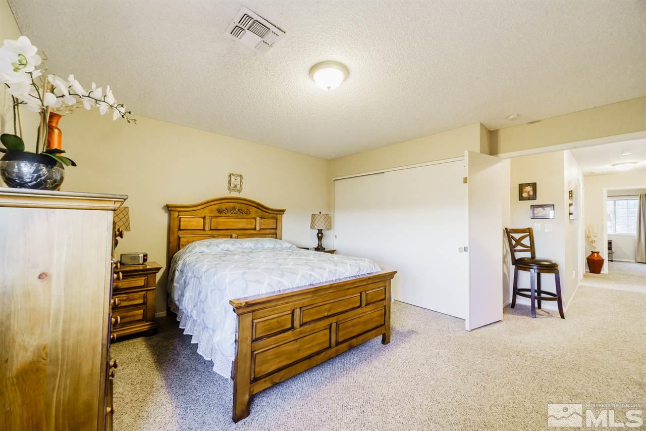4275 Perro Lane Reno, NV 89502 - Photo 26 of 32 a bedroom with a bed and a table in it