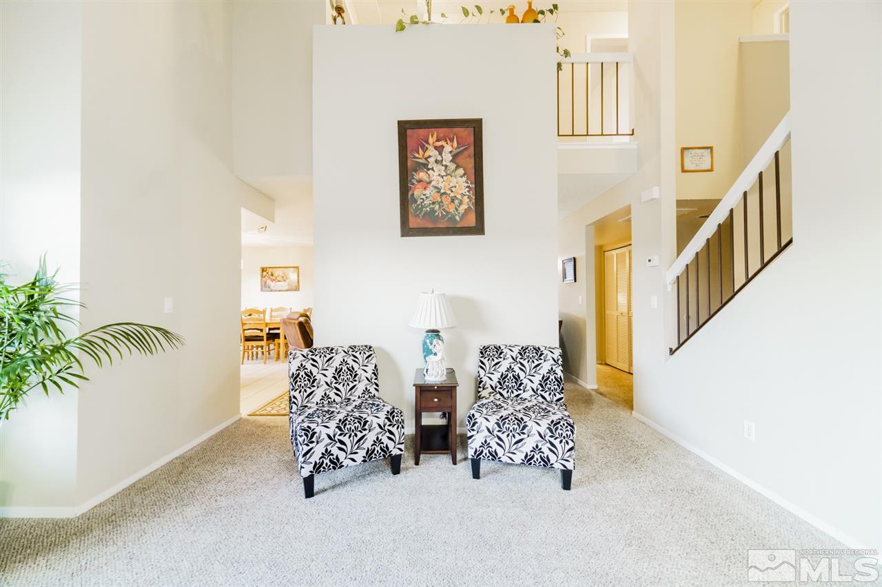 4275 Perro Lane Reno, NV 89502 - Photo 5 of 32 a living room with couches painting on the wall and a potted plant